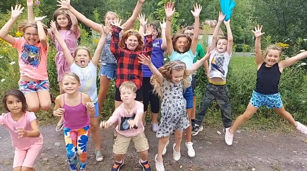 kids jumping in air with arms up