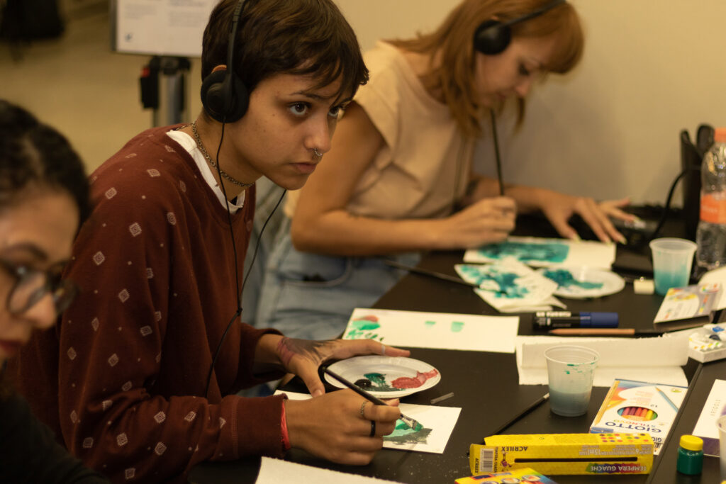 Focused young person painting.