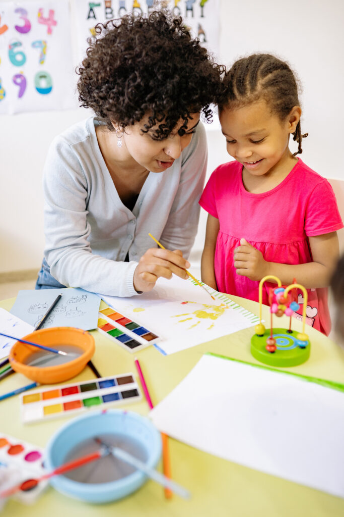 Teacher and young girl in classroom