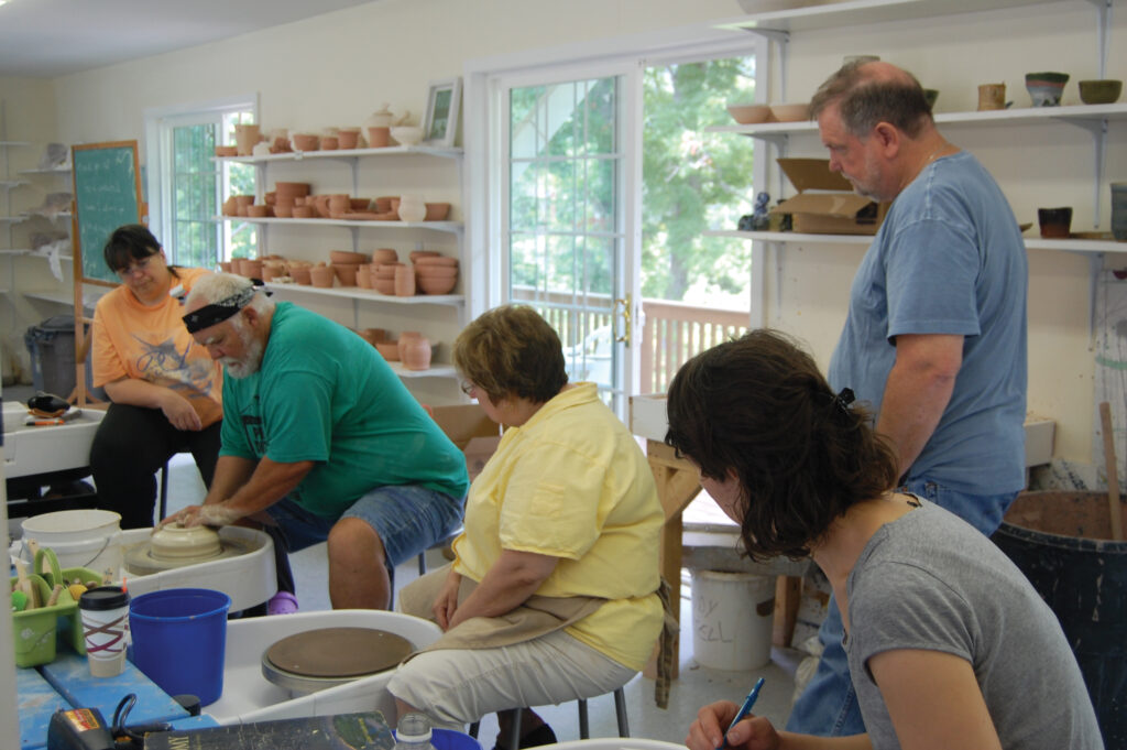 Group of students in pottery workshop.