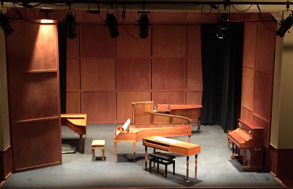 Group of historic pianos on stage at Doctorow