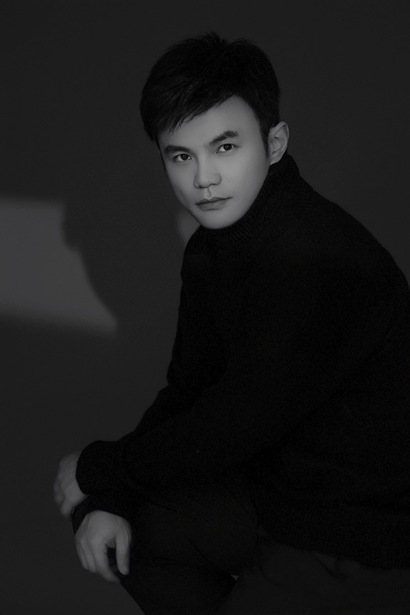 Black and white headshot of pianist Heqing Huang