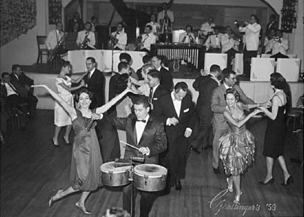 Vintage photo of a man playing drums and people dancing
