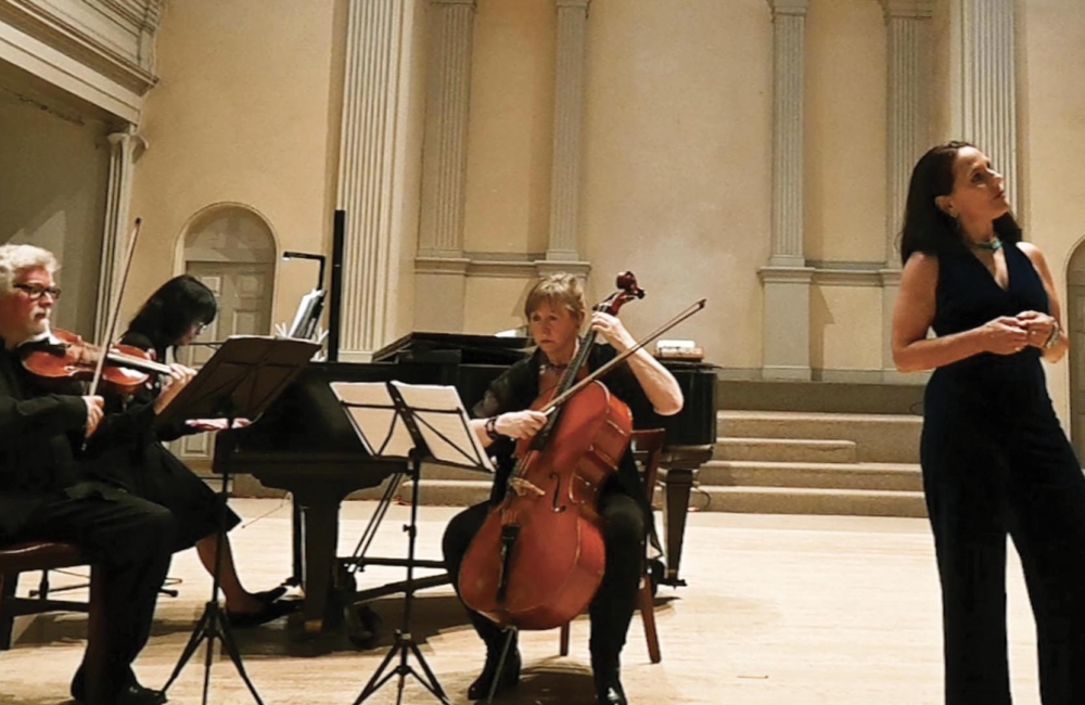 Violinist, pianist, cellist, and singer perform