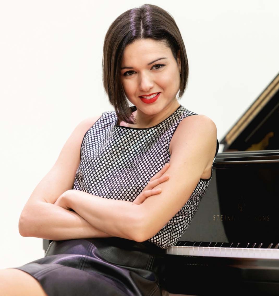 Woman sitting at a grand piano