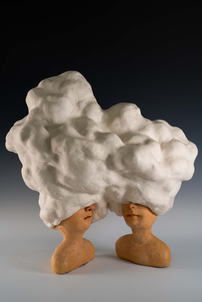 Two busts with heads that look like clouds